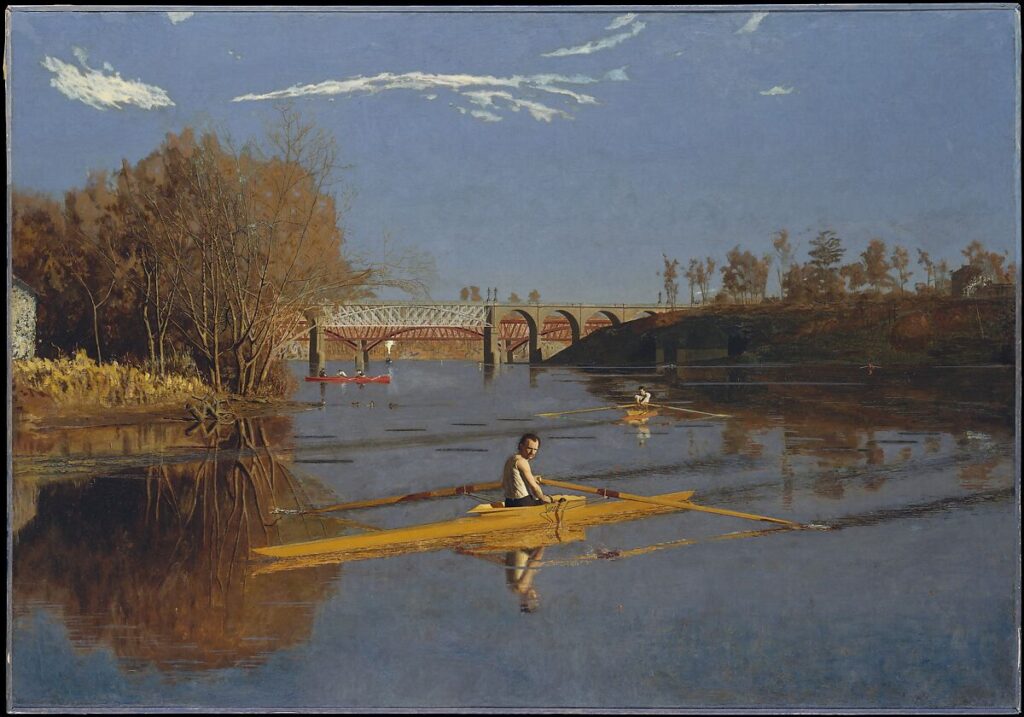 Un canottiere solo sul fiume, simbolo della competizione e della solitudine moderna.